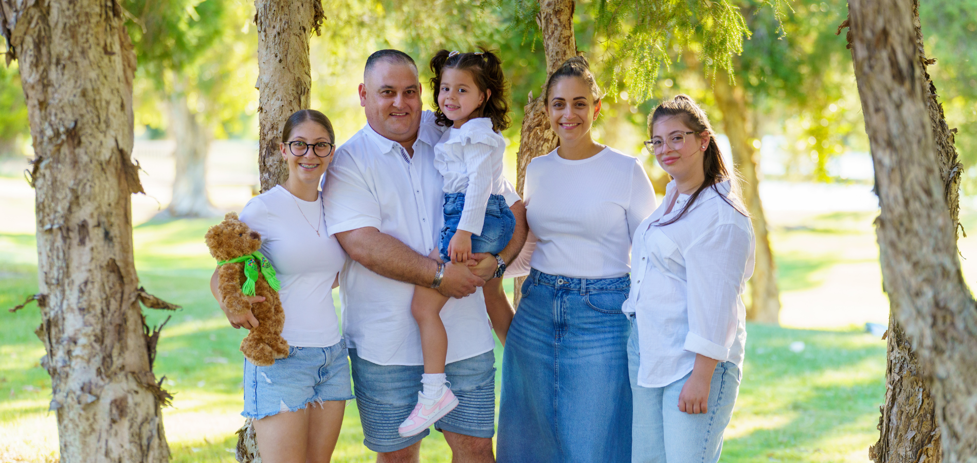 Mia, Andrew, Angelia, Gab and Toni with one of Angelia's many The Kids' Cancer Project bears while receiving treatment.