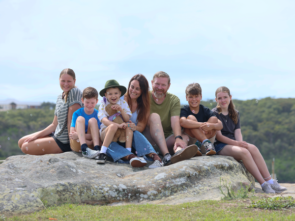 Bobby with his bunny, brothers, sisters and parents.